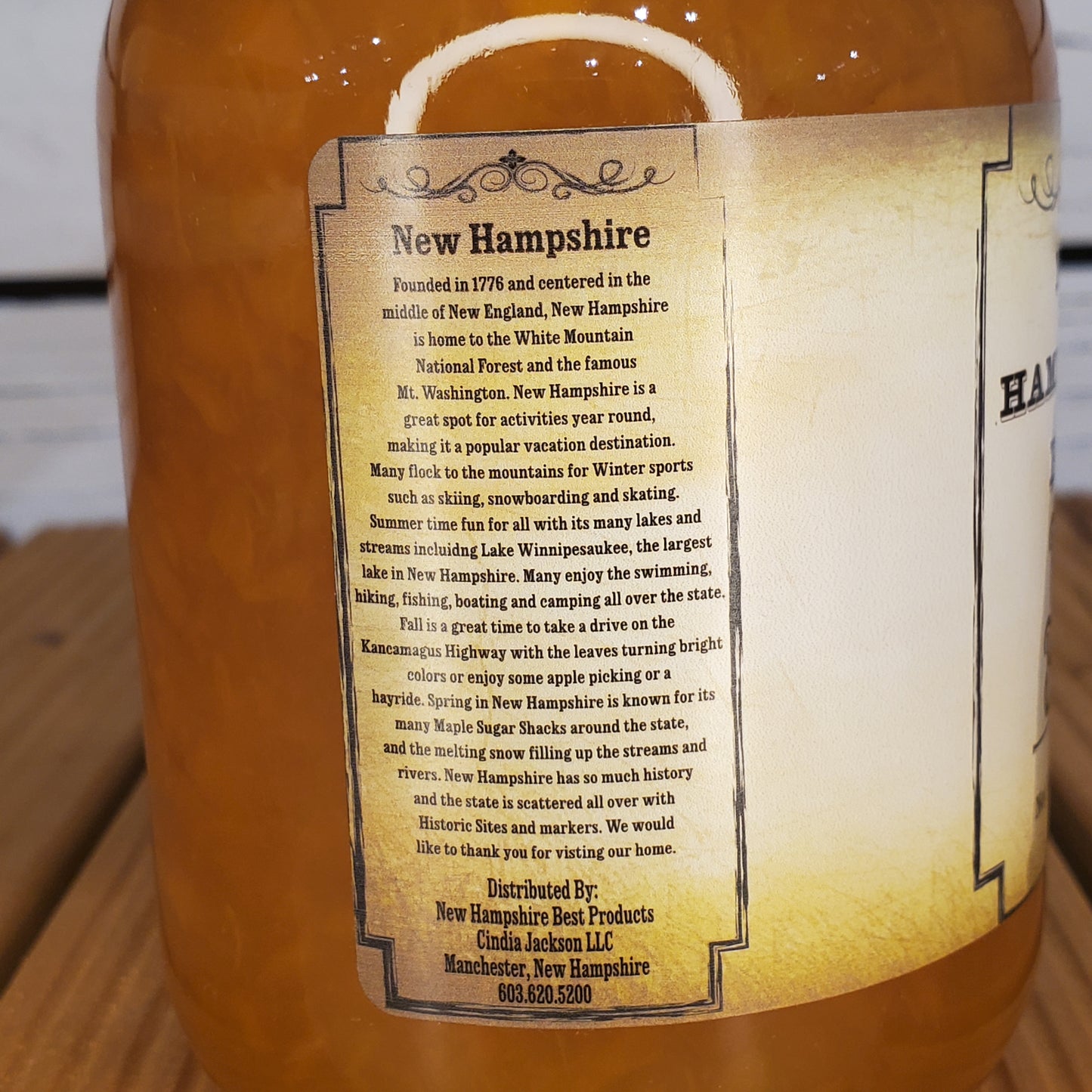 Close-up of a bottle label with text on a wooden surface
