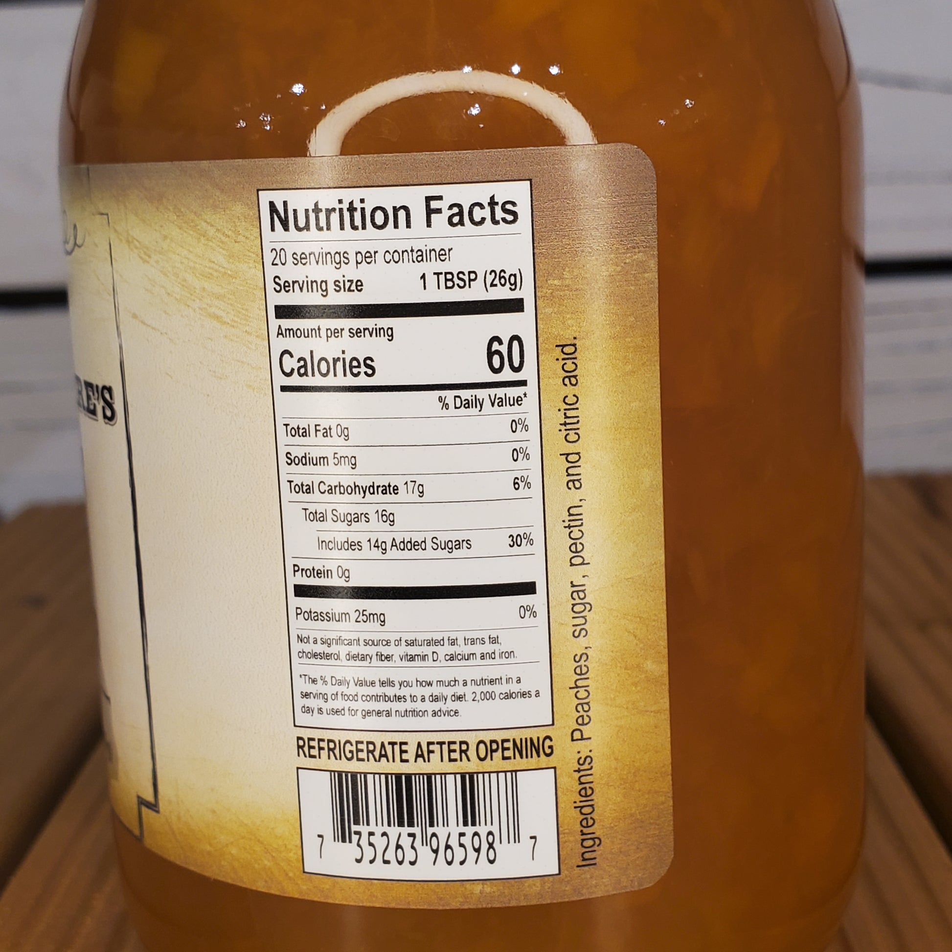 Close-up of a jar with a nutrition facts label on a wooden surface