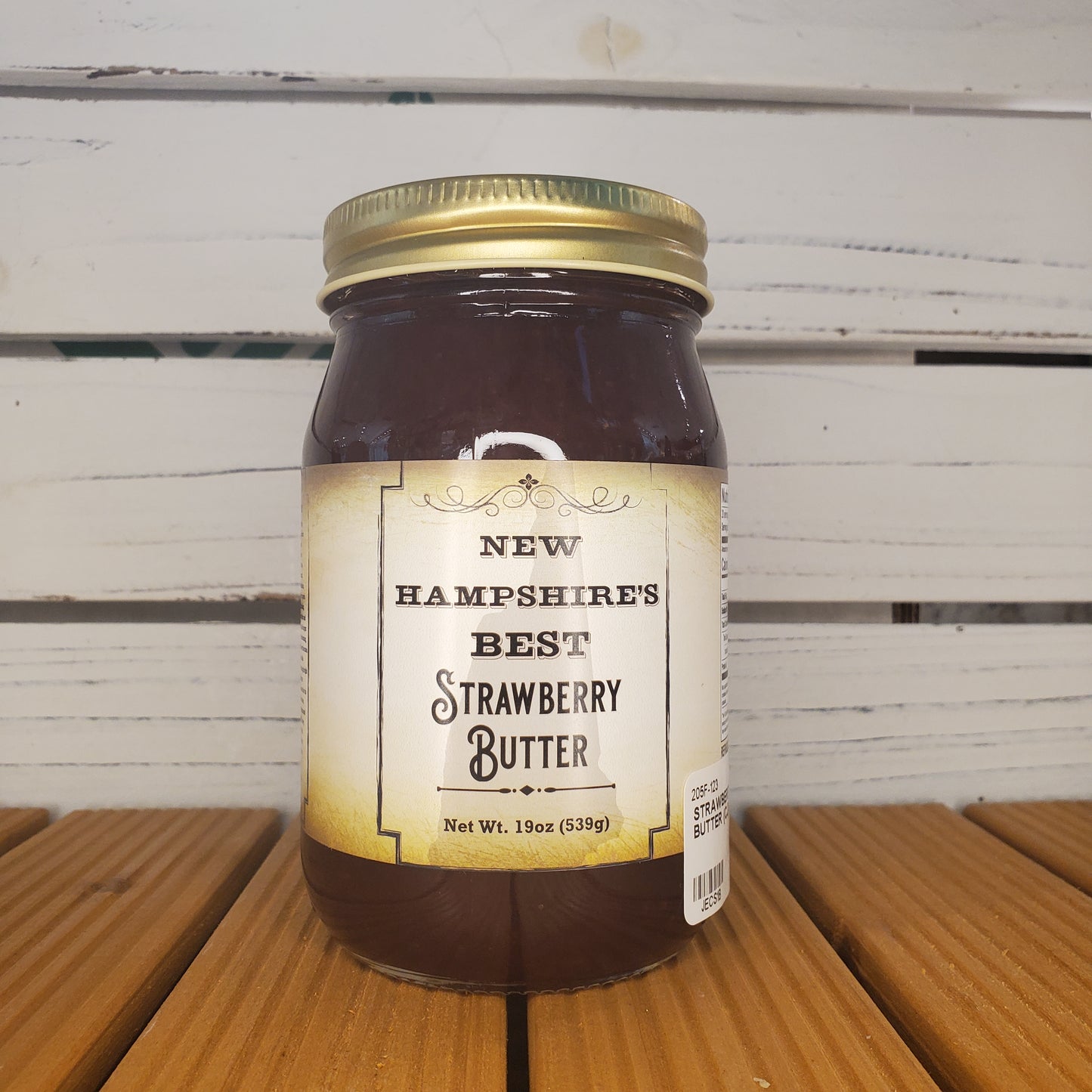 Jar of New Hampshire's Best Strawberry Butter on a wooden surface