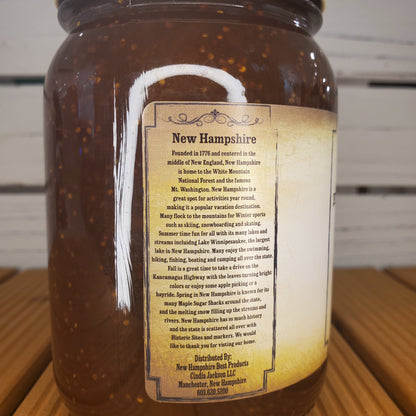 Jar of New Hampshire honey with a label on a wooden surface