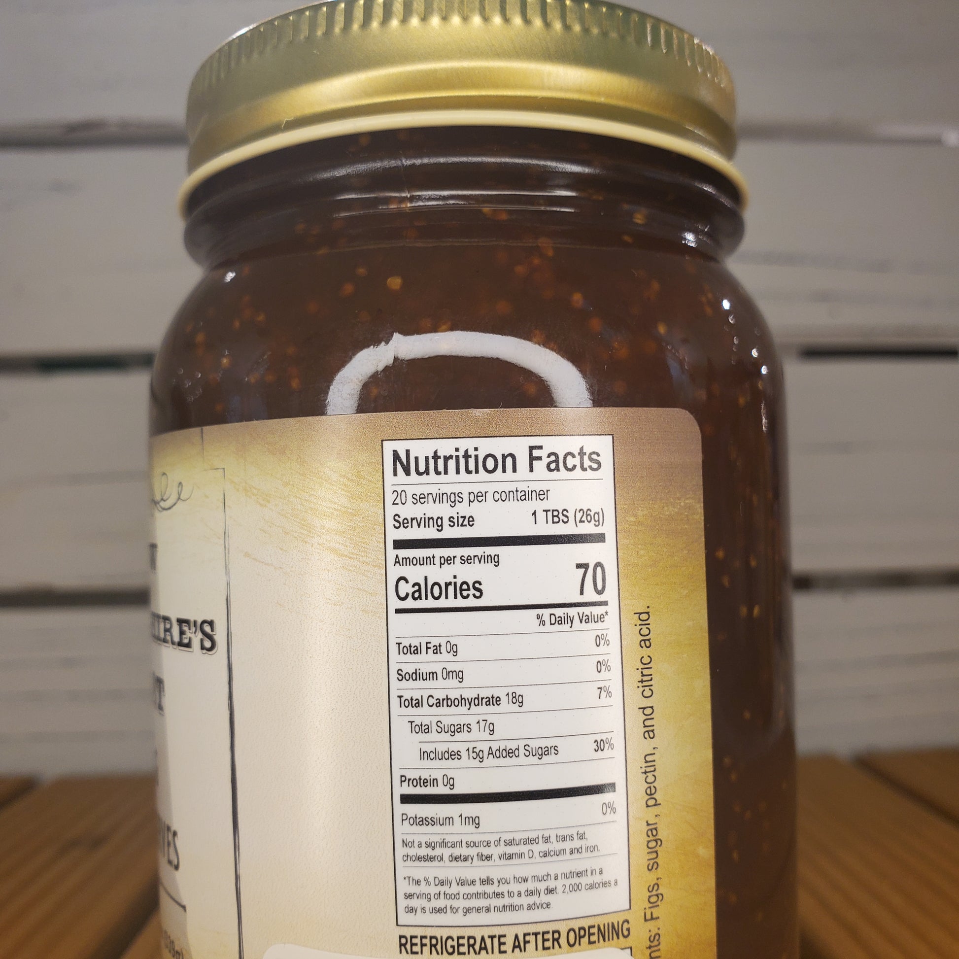Jar of preserves with a nutrition facts label on a wooden surface