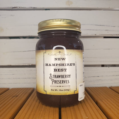 Jar of New Hampshire Best Strawberry Preserves on a wooden surface