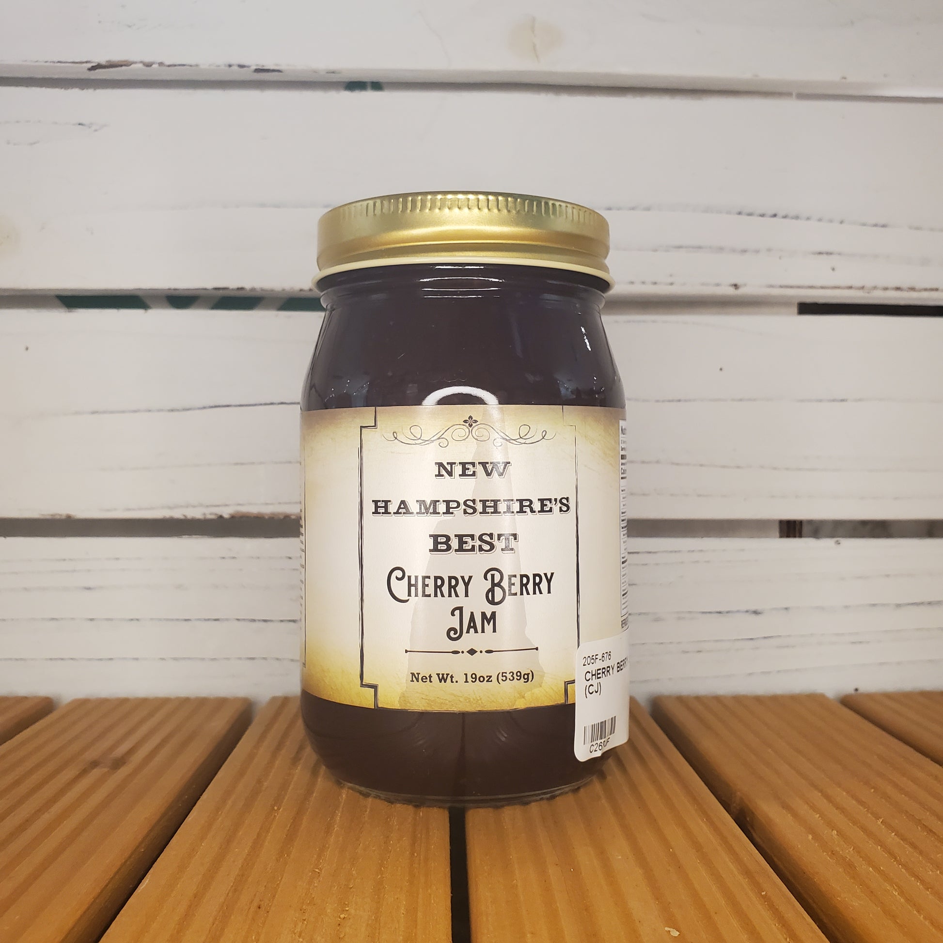 Jar of New Hampshire's Best Cherry Berry Jam on a wooden surface