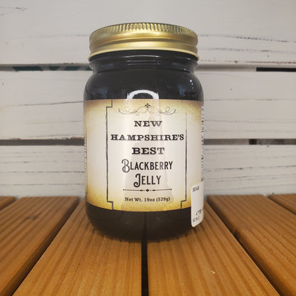 Jar of New Hampshire's Best Blackberry Jelly on a wooden surface