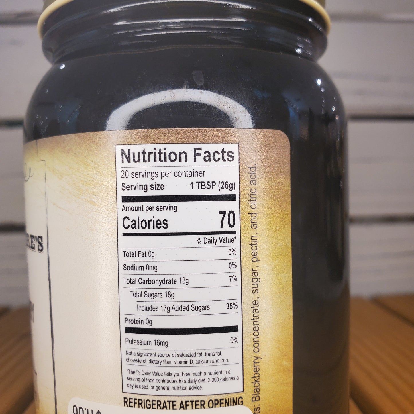 Close-up of a bottle label with nutritional information on a wooden surface