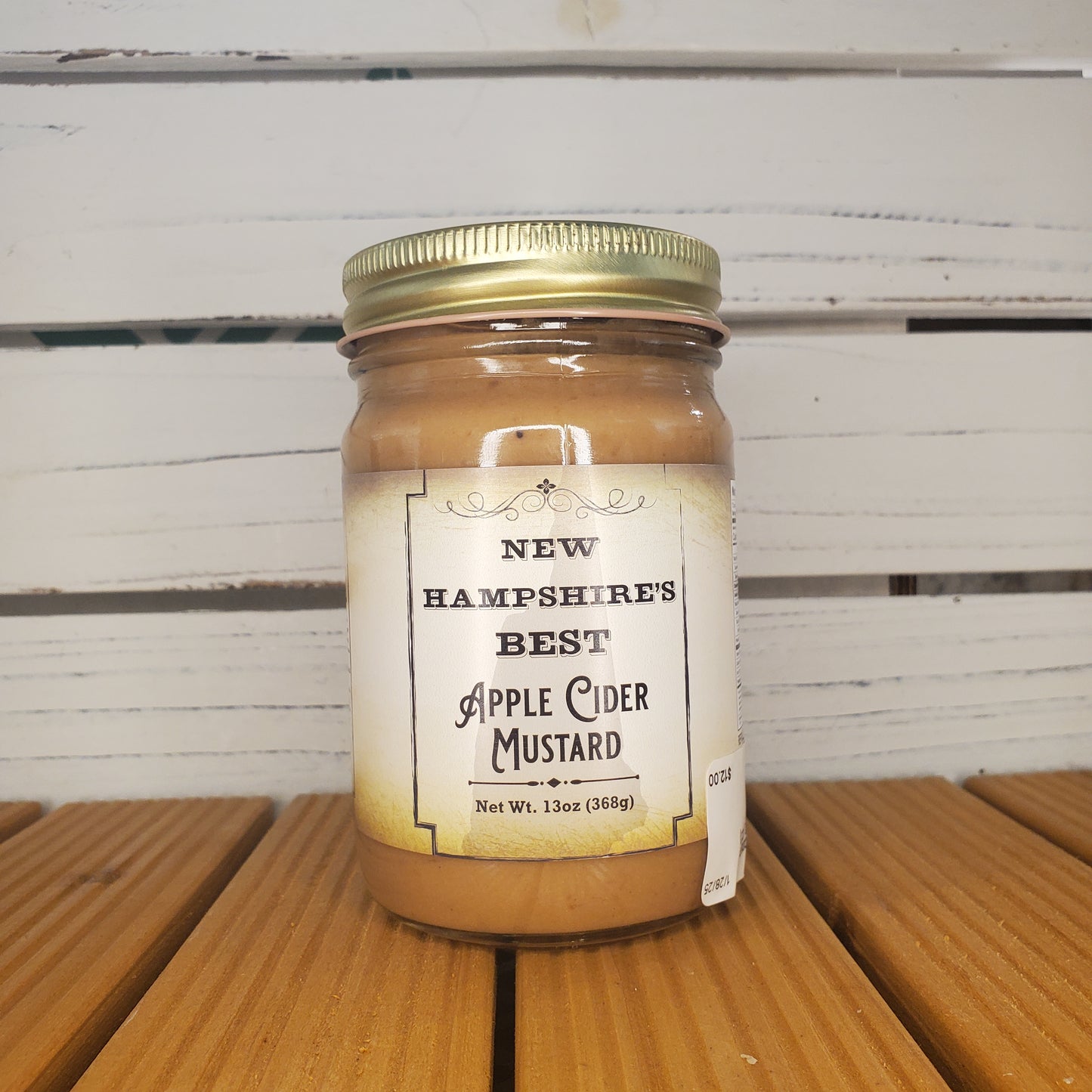 Jar of New Hampshire's Best Apple Cider Mustard on a wooden surface