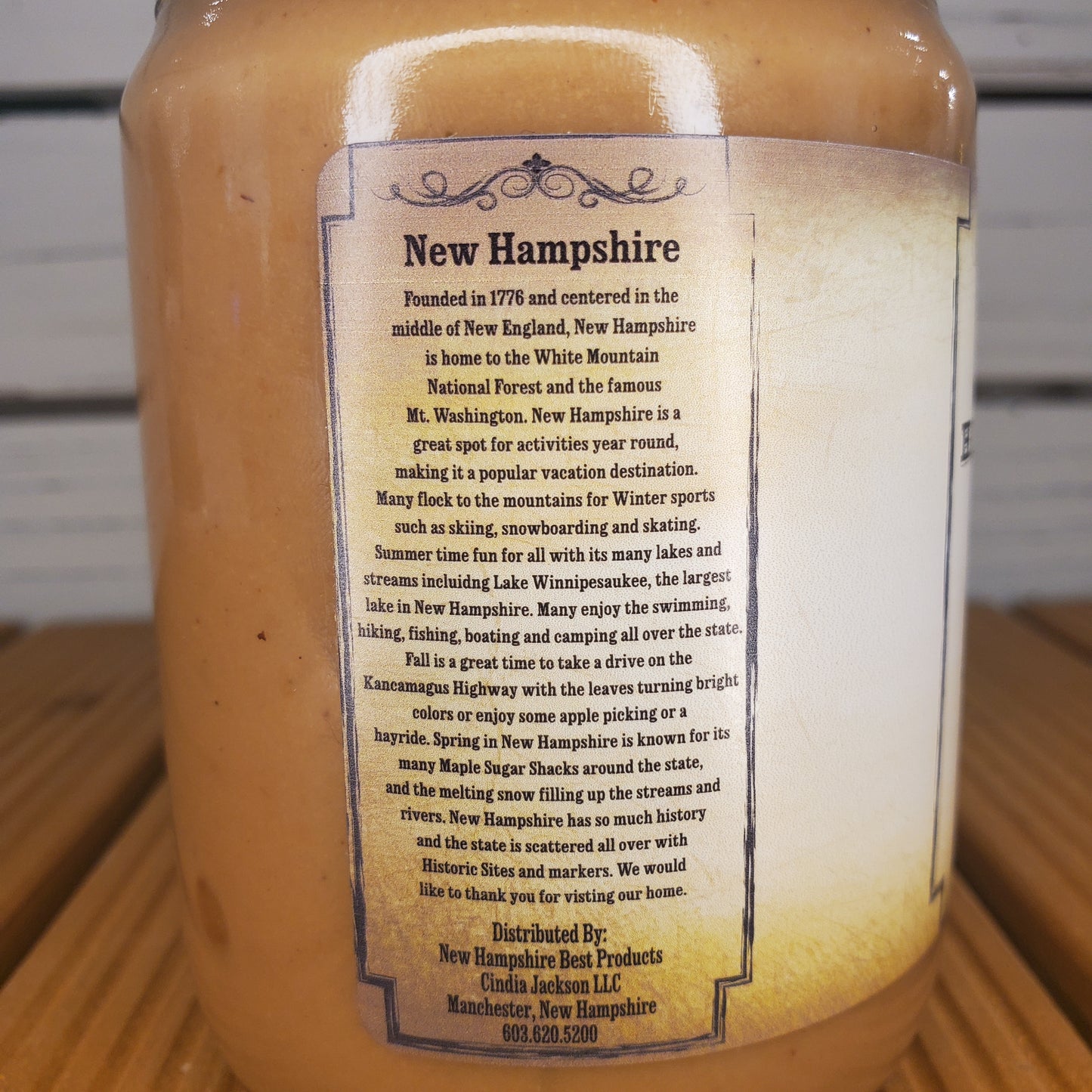 Jar with a label about New Hampshire on a wooden surface