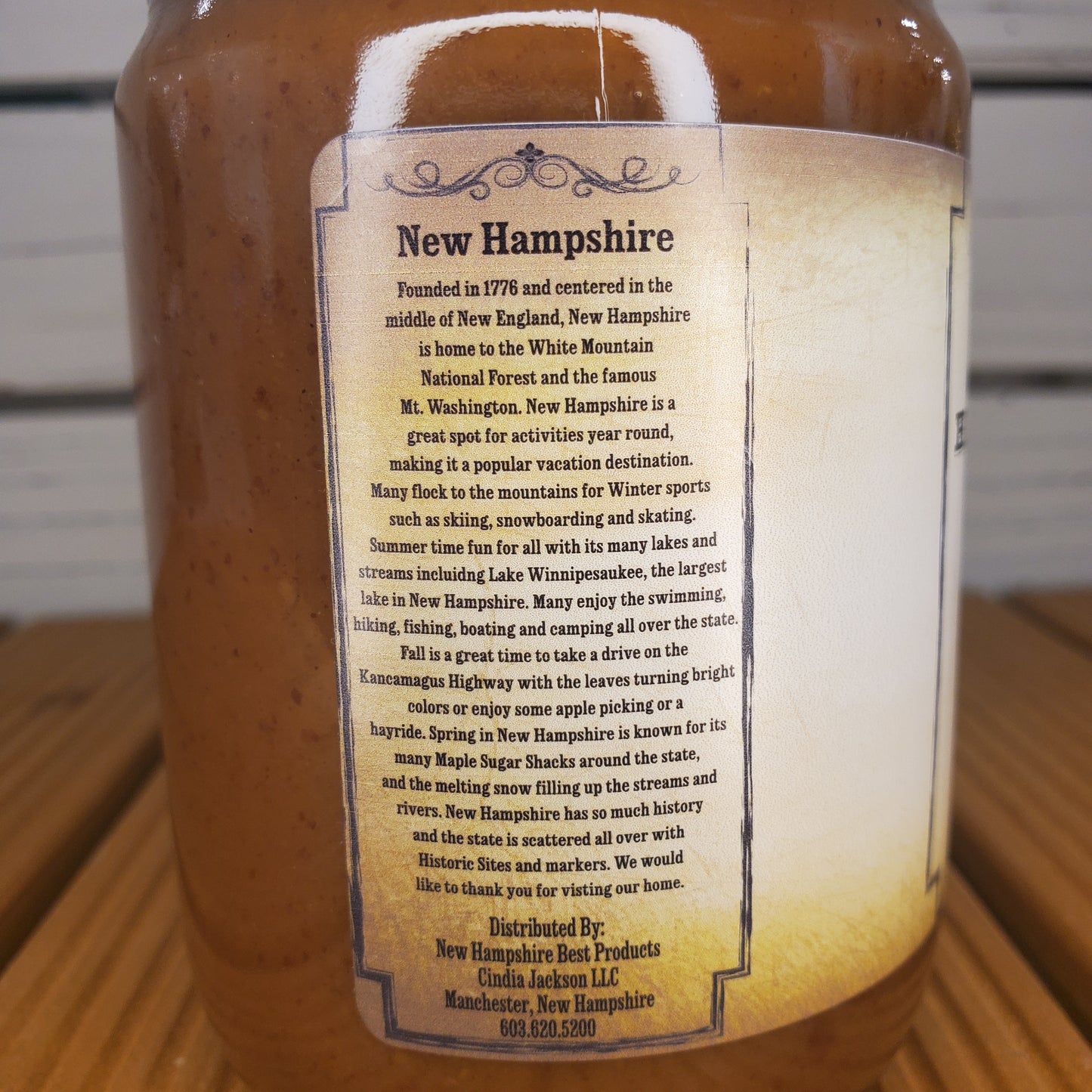 Bottle with a label about New Hampshire on a wooden surface
