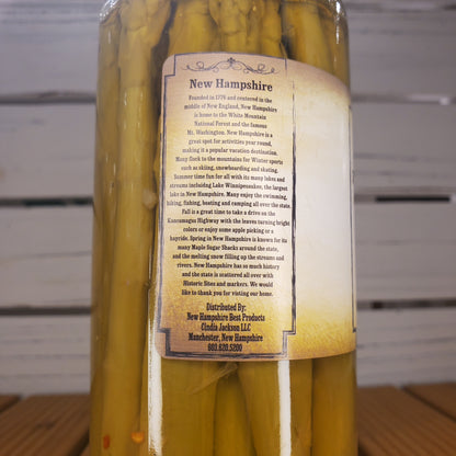 Bottle of yellow liquid with a label on a white background