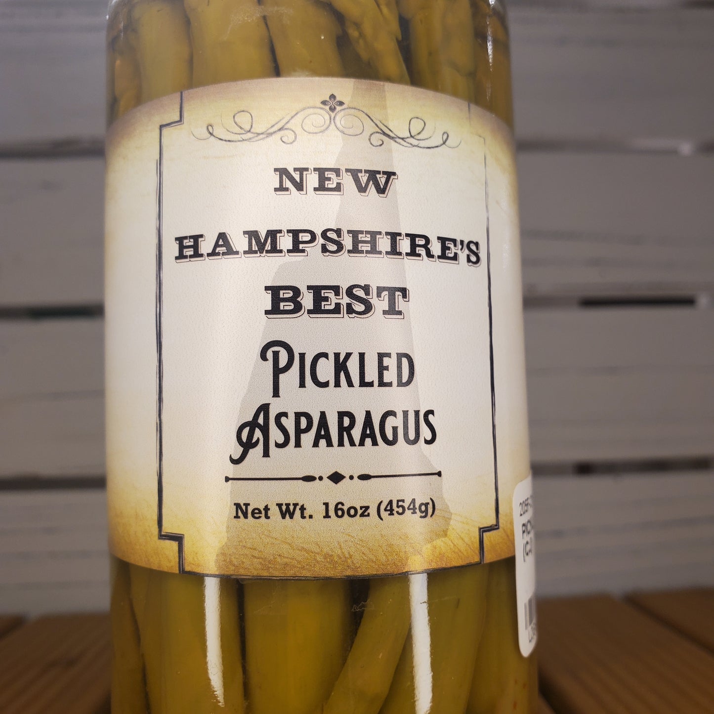Bundled pickled asparagus with a label on a wooden surface