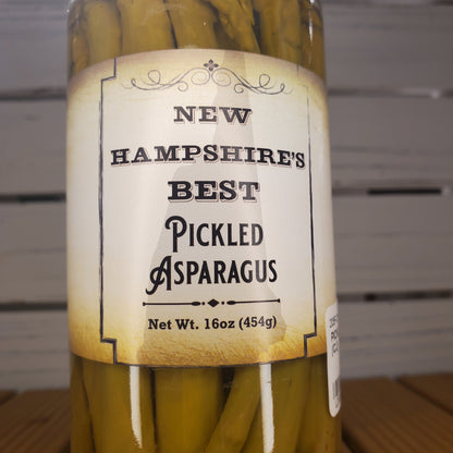 Bundled pickled asparagus with a label on a wooden surface