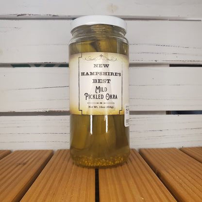 Jar of pickled oregano on a wooden surface