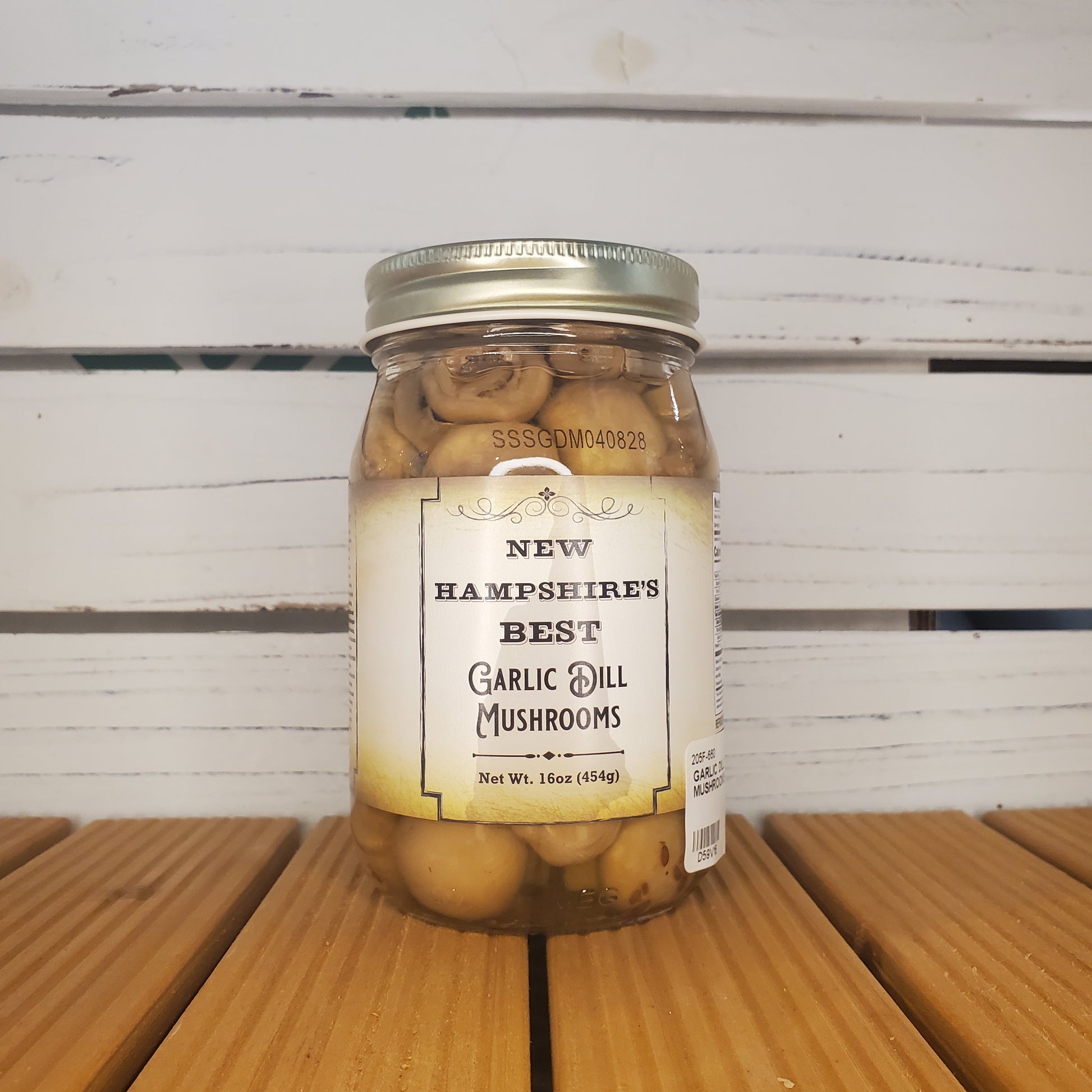 Jar of mushrooms with a label on a wooden surface