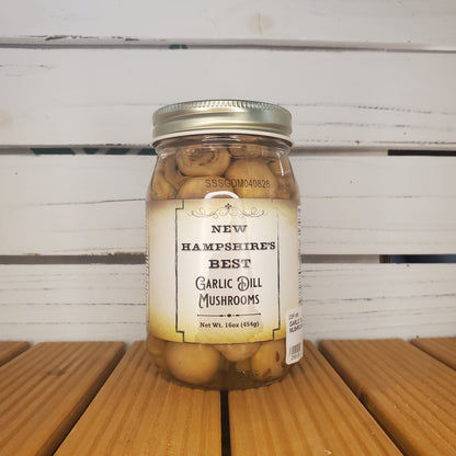 Jar of mushrooms with a label on a wooden surface