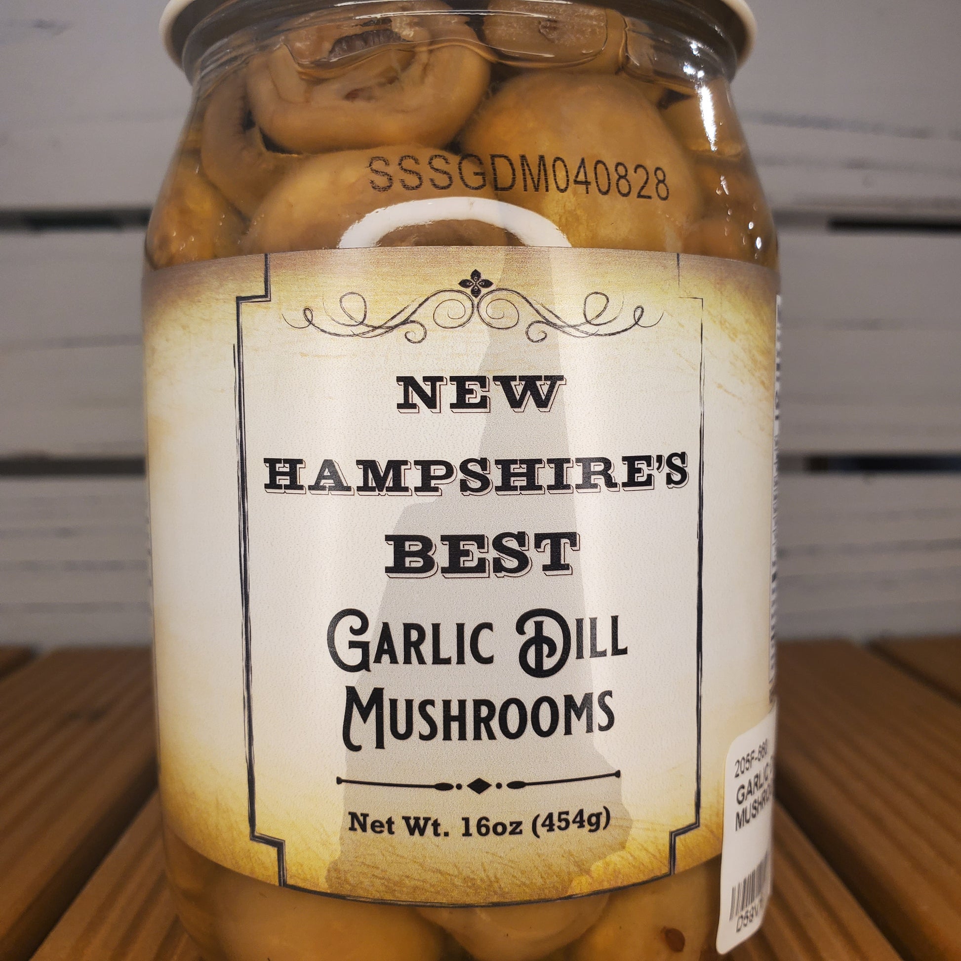 Jar of New Hampshire's Best Garlic Mushrooms with a label on a white background