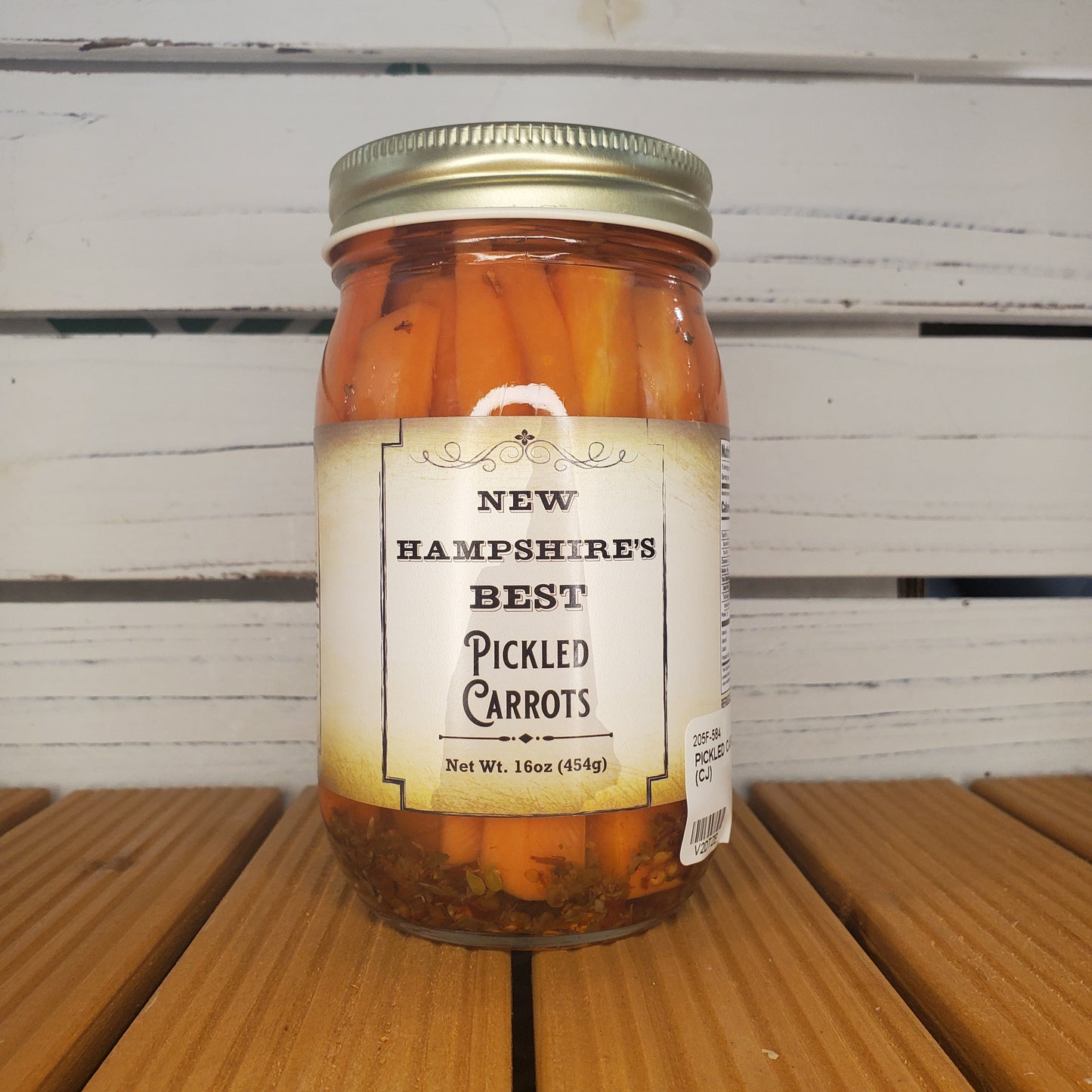 Jar of New Hampshire's Best Pickled Carrots on a wooden surface