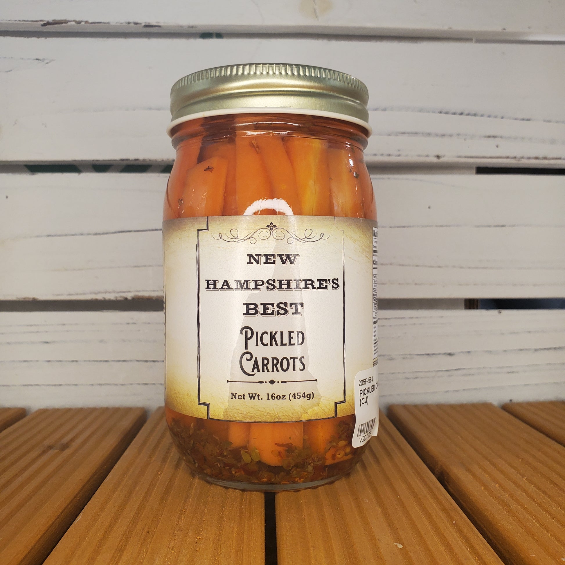 Jar of New Hampshire's Best Pickled Carrots on a wooden surface
