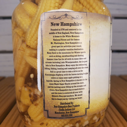 Corn on a cob with a New Hampshire label on a wooden surface