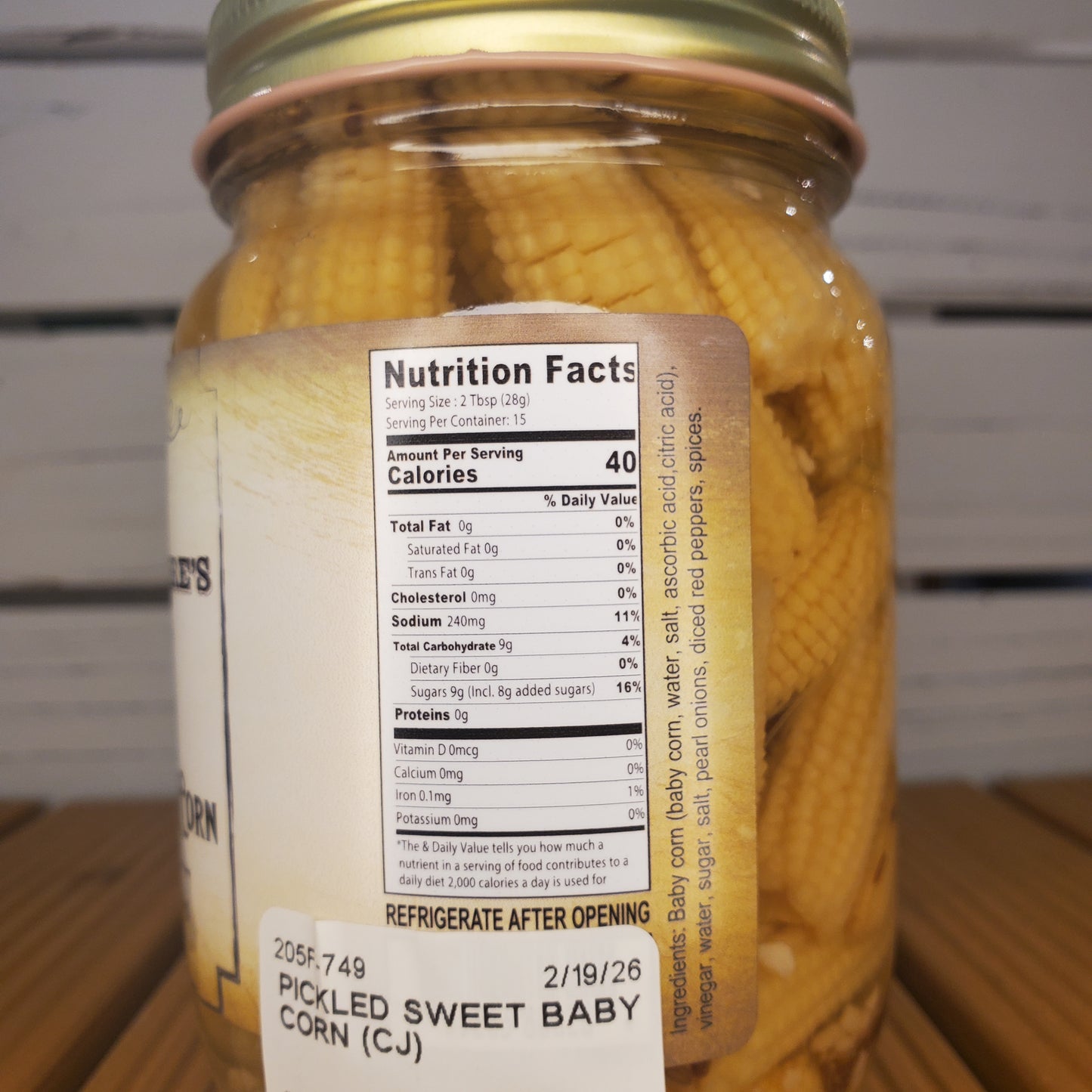 Jar of pickled corn with a nutrition label on a metal surface