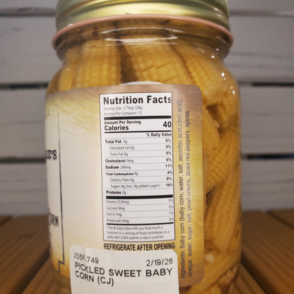 Jar of pickled corn with a nutrition label on a metal surface