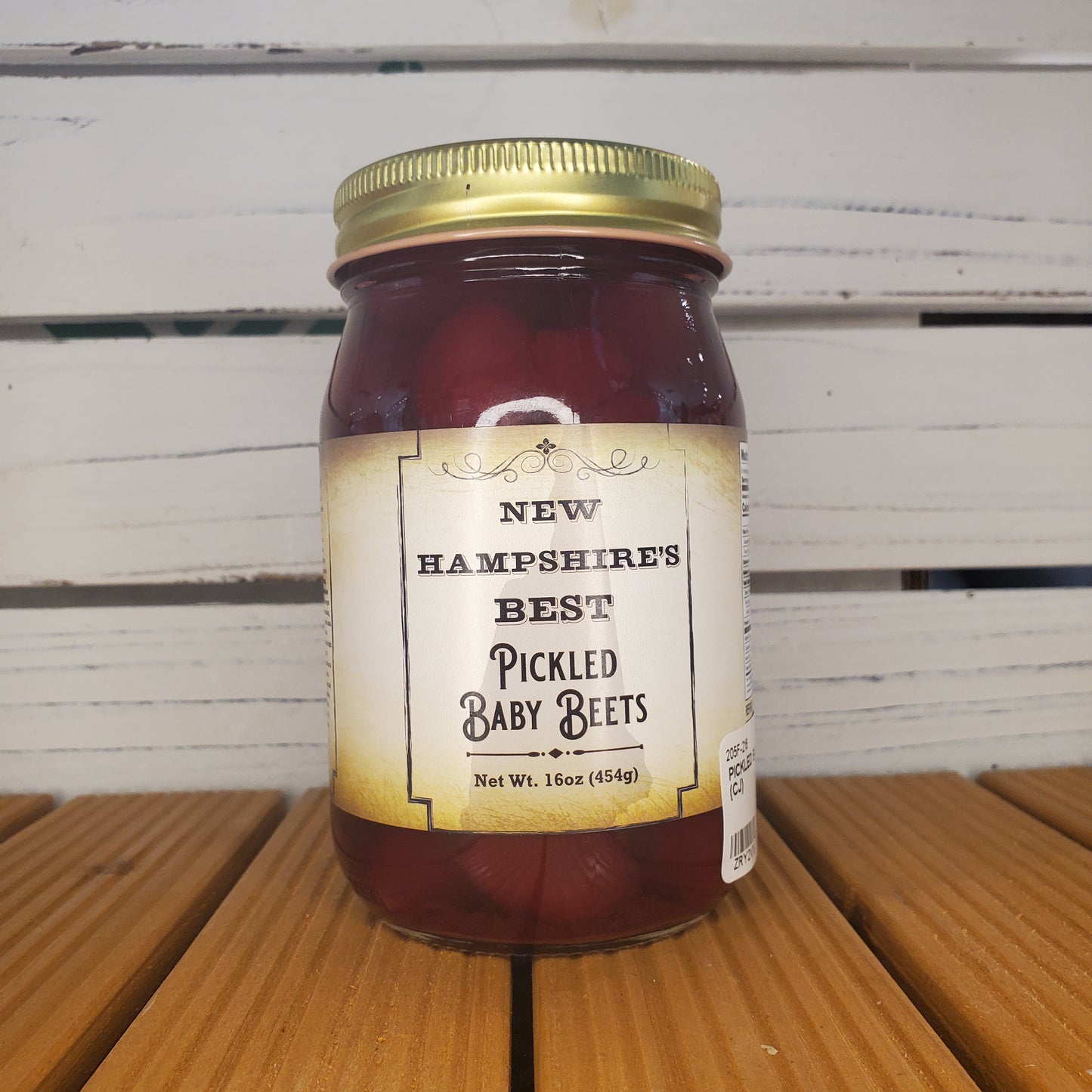Jar of New Hampshire's Best Pickled Baby Bees on a wooden surface