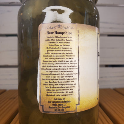 Bottle with a label about New Hampshire on a wooden surface.