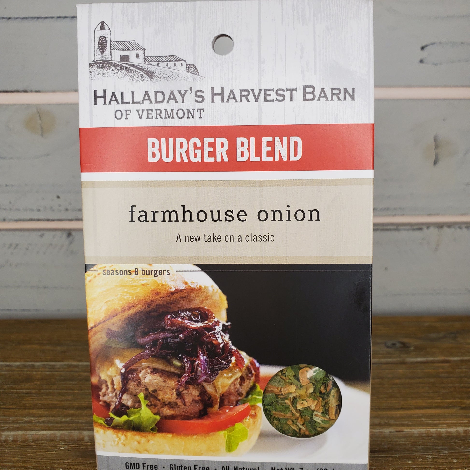 Halladay's Harvest Barn burger blend packaging with a burger image on a wooden surface.