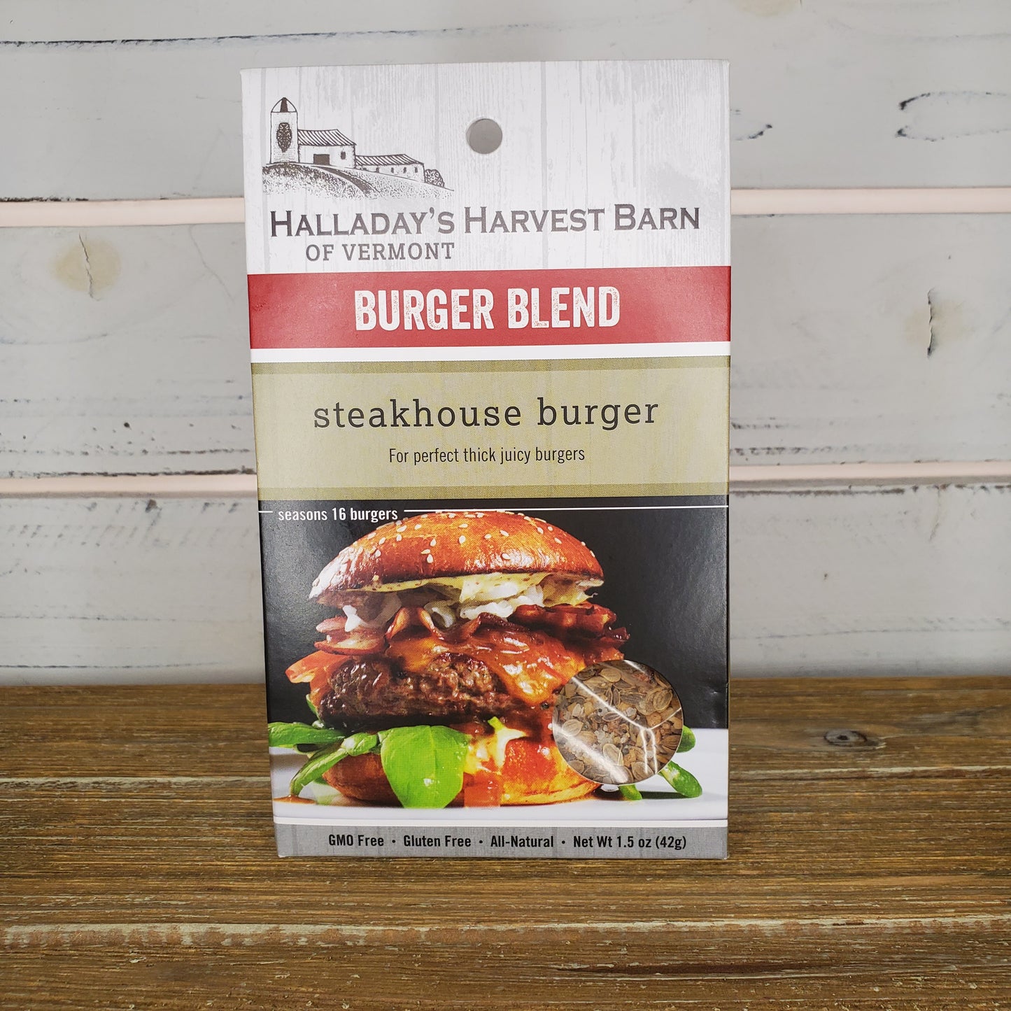 Packaging of Halladay's Harvest Barn of Vermont Burger Blend Steakhouse burger on a wooden surface.