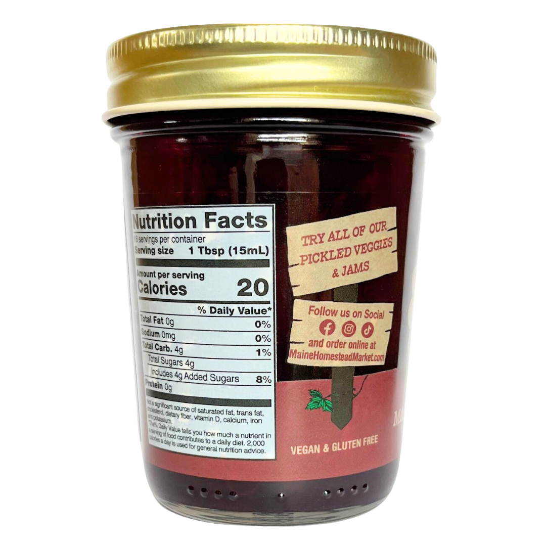 A glass jar of Maintenta's Organic Pickled Vegetables & Jams with a gold metal lid, showing the Nutrition Facts label and product branding on a white background.