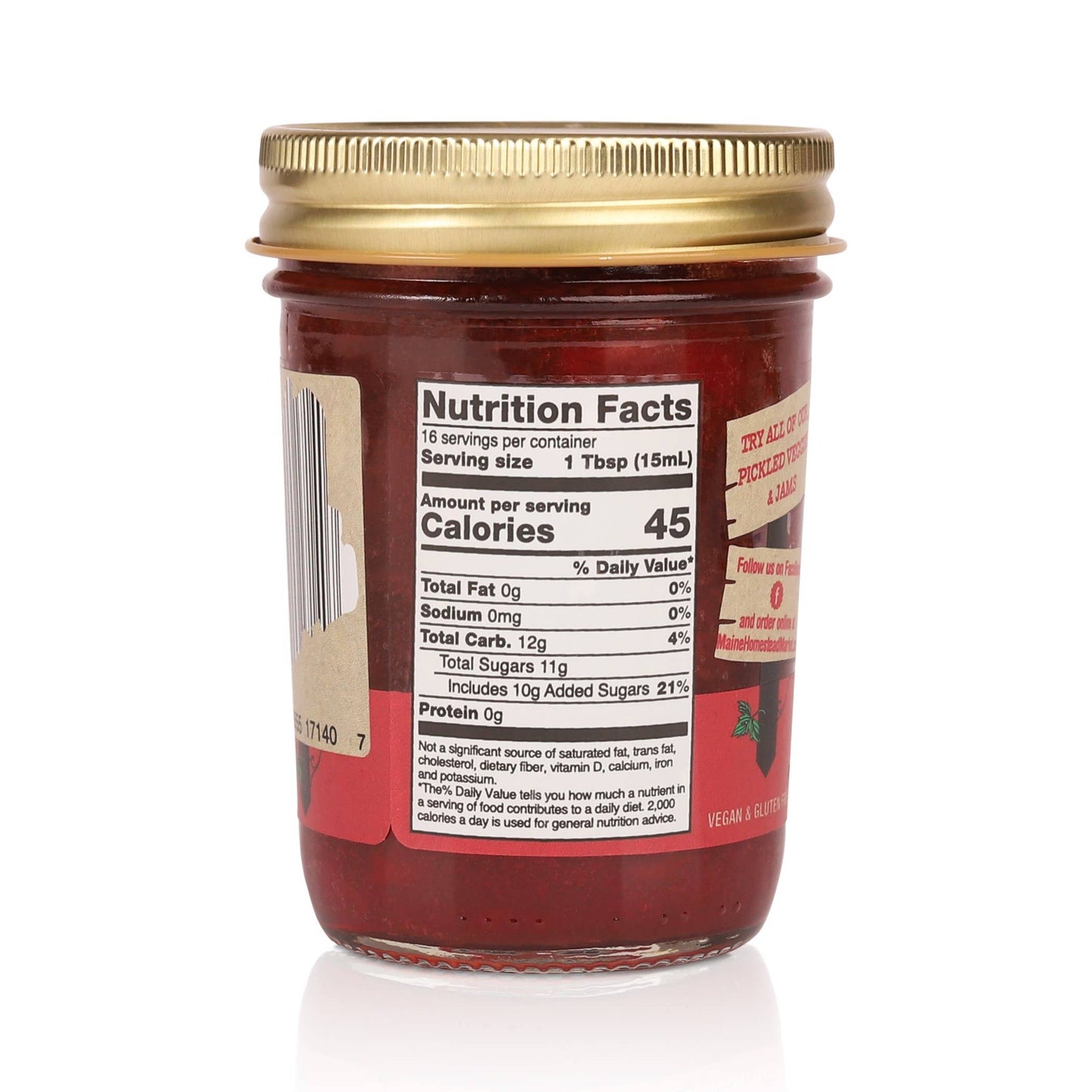 A glass jar of Texas Sweet Co. fruit spread shown from the back, featuring a gold metal lid and a red label with a visible Nutrition Facts panel.