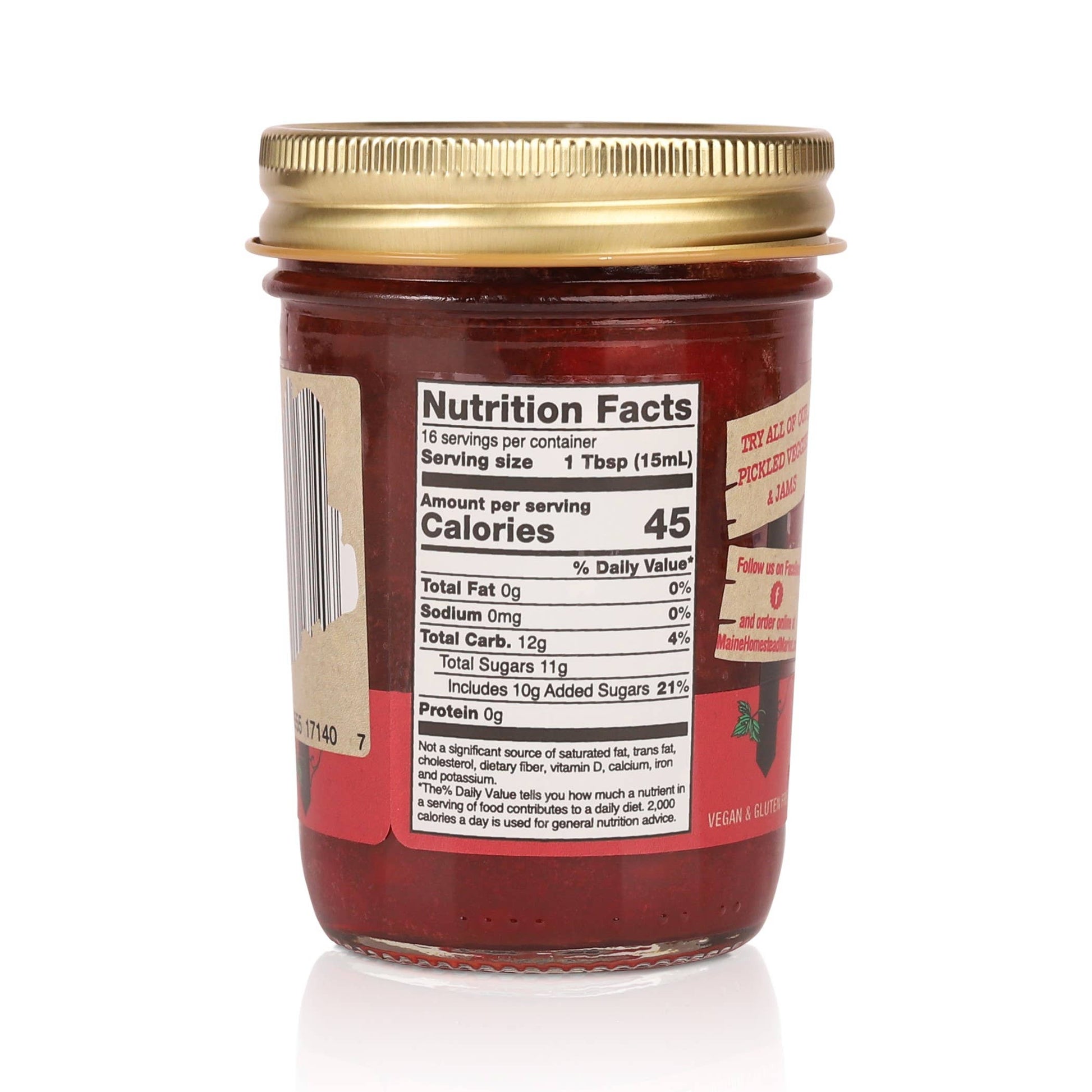 A glass jar of Texas Sweet Co. fruit spread shown from the back, featuring a gold metal lid and a red label with a visible Nutrition Facts panel.
