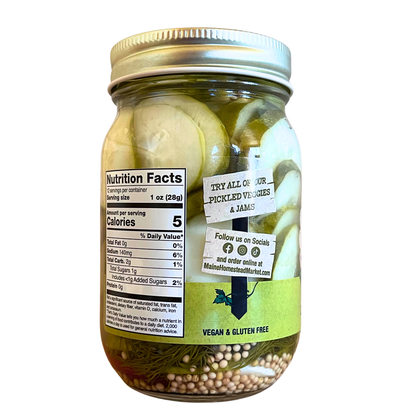 A glass mason jar filled with sliced pickled onions and herbs, sealed with a silver metal lid. The jar has a white nutrition facts label and a green sticker that reads 'VEGAN & GLUTEN FREE', set against a plain white background.