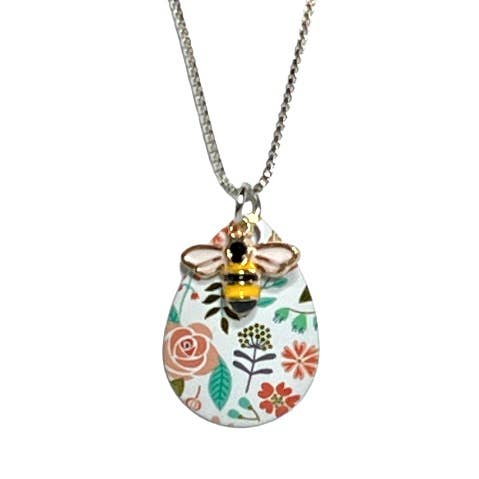 A silver chain necklace with a decorative pendant featuring a colorful floral pattern and a small bumblebee charm, shown against a plain white background.