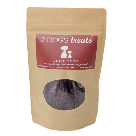 A 3.0 oz stand-up pouch of 2 Dogs Treats 'Just Beef' dog treats, made from natural kraft paper with a dark red label and a clear window showing the beef treats inside.