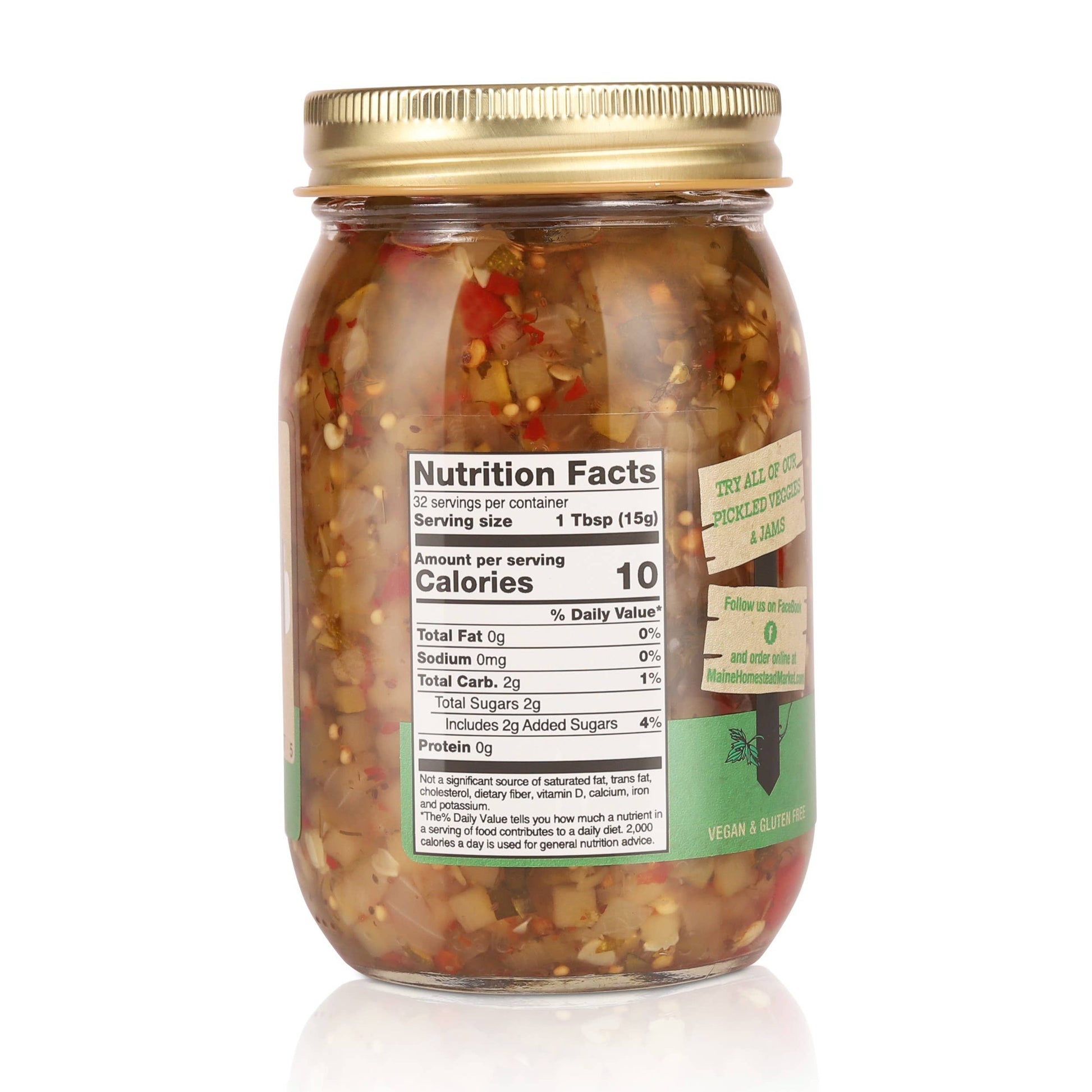 A glass jar of chopped chili peppers and onions with a gold metal lid, showing a visible nutrition facts label on the front, set against a plain white background.