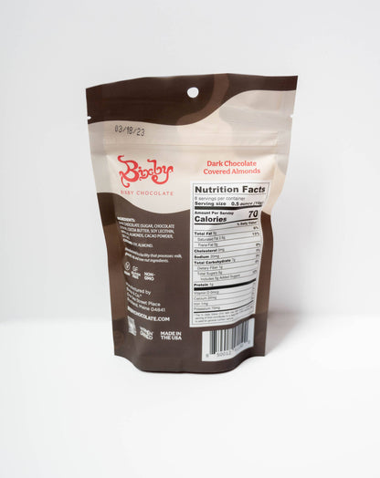 A stand-up pouch of Brista Dark Chocolate Covered Almonds, showing the back of the package with the brand logo, nutrition facts, and barcode on a clean white background.