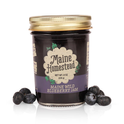 Jar of Maine Homestead Maine Wild Blueberry Jam with blueberries on a white background