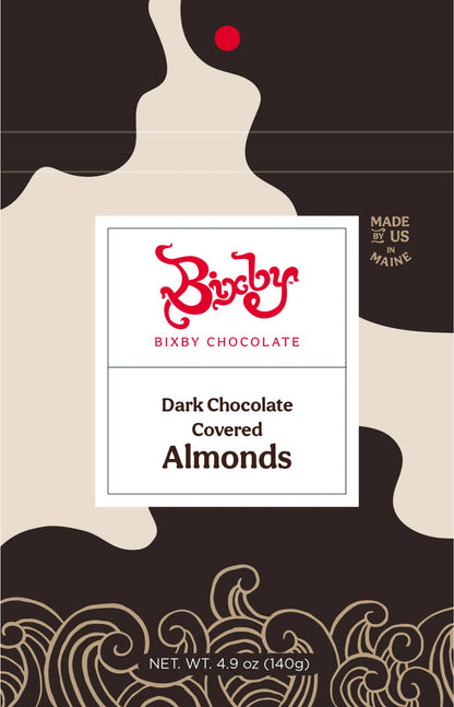 Bixby Chocolate Dark Chocolate Covered Almonds packaging, featuring a white central label with red and black text, set against a dark brown and beige abstract background with gold decorative flourishes at the bottom.