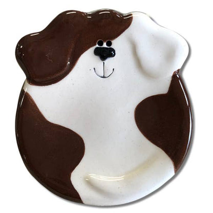 Dog-shaped ceramic plate with brown and white design on a white background