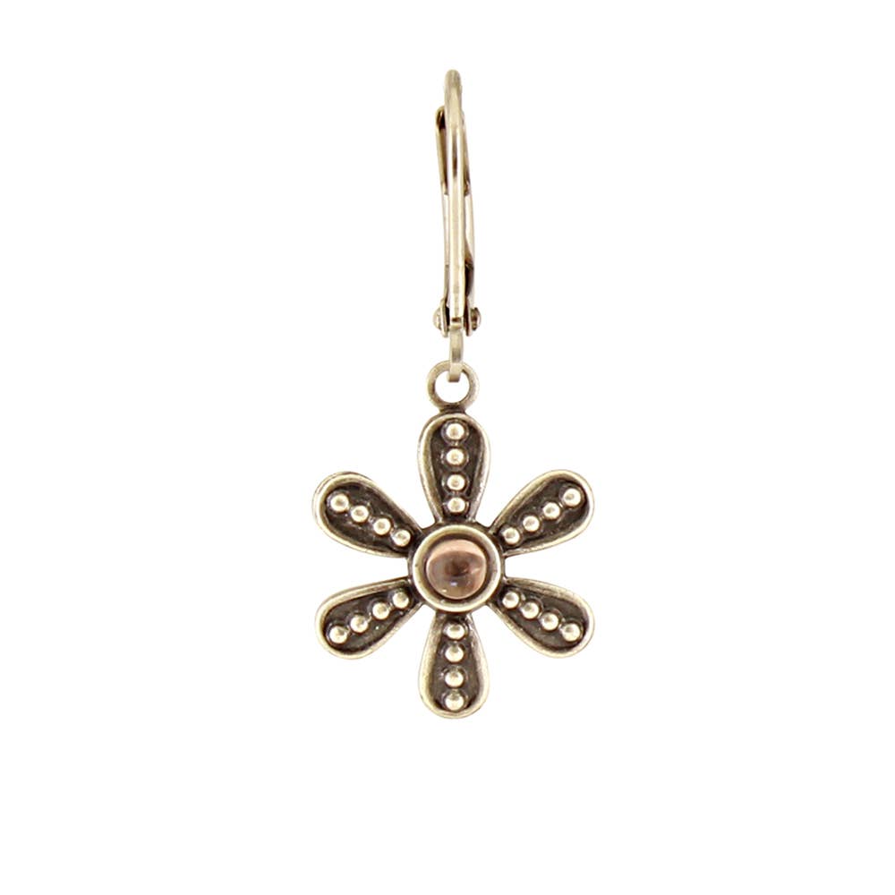 Gold flower-shaped earring on a white background