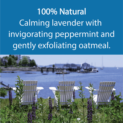 A scenic outdoor coastal scene with three white Adirondack chairs facing the water, surrounded by green plants and purple flowers. A large blue text banner at the top reads: '100% Natural Calming lavender with invigorating peppermint and gently exfoliating oatmeal.