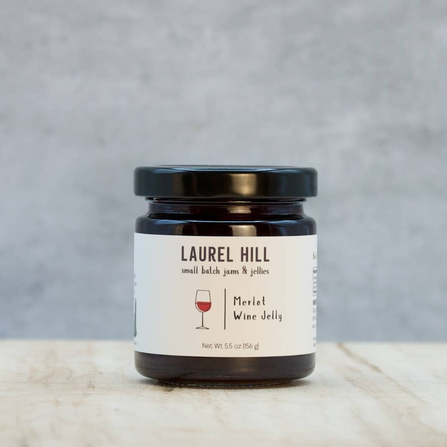 Jar of Laurel Hill Merlot Wine Jelly on a marble surface with a gray background