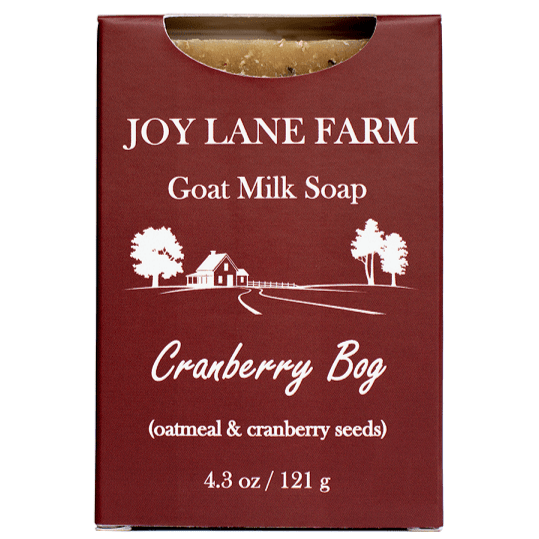 A rectangular box of Joy Lane Farm Goat Milk Soap in the Cranberry Bog scent, featuring a deep burgundy-red background with white text and a white line drawing of a farm scene.