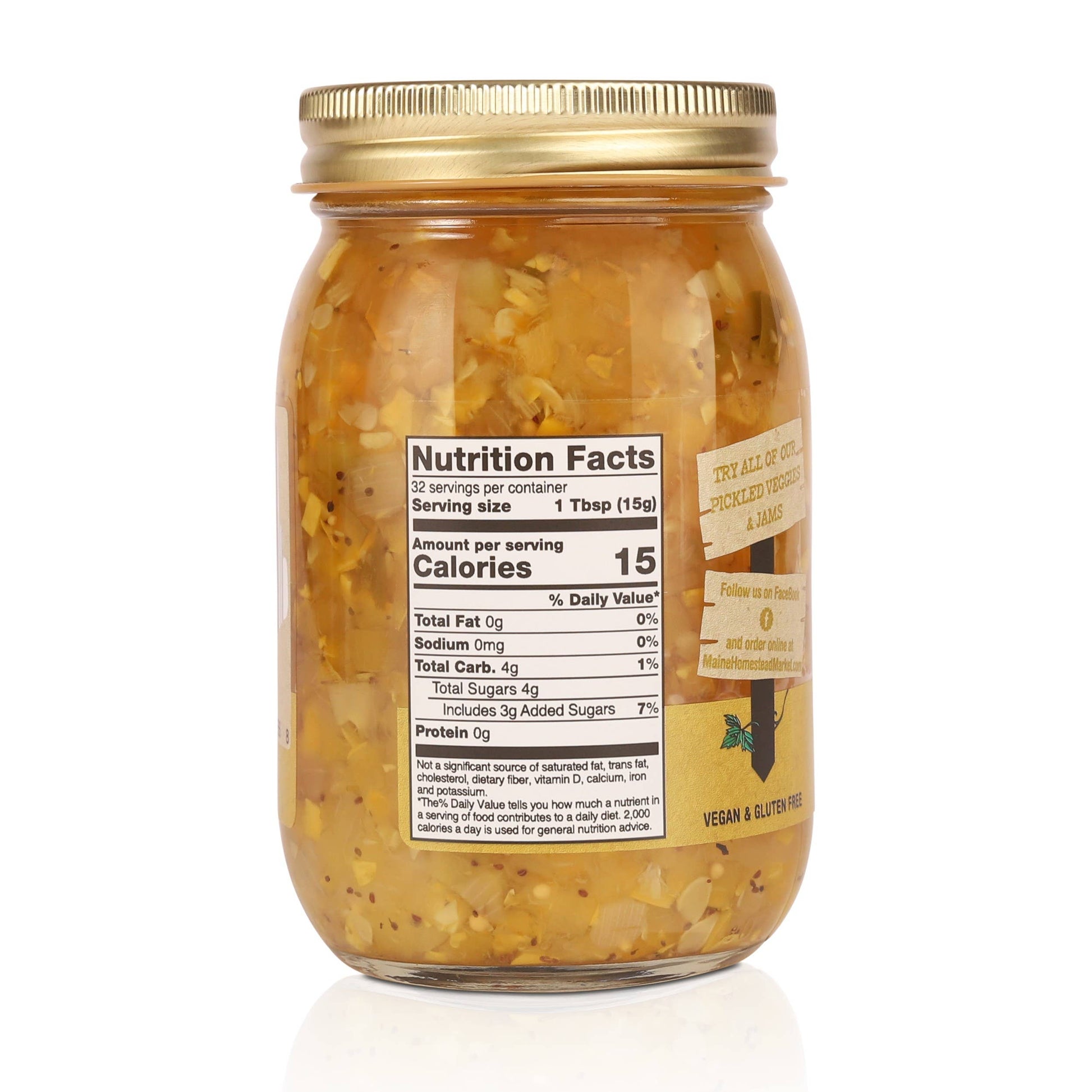 A glass jar of vegan and gluten-free sautéed onions with garlic, featuring a gold metal lid and a gold side label, shown on a white background with a faint reflection.