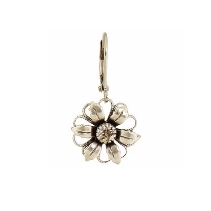 Floral silver earring on a white background