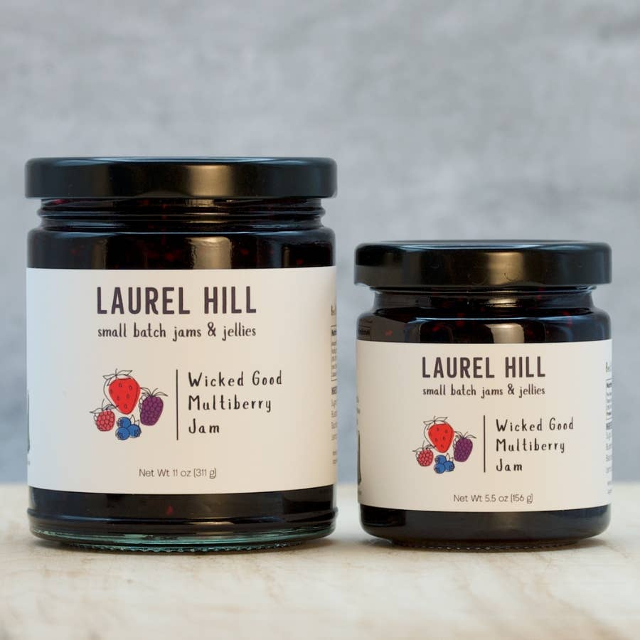 Two jars of Laurel Hill Wicked Good Multiberry Jam on a neutral background