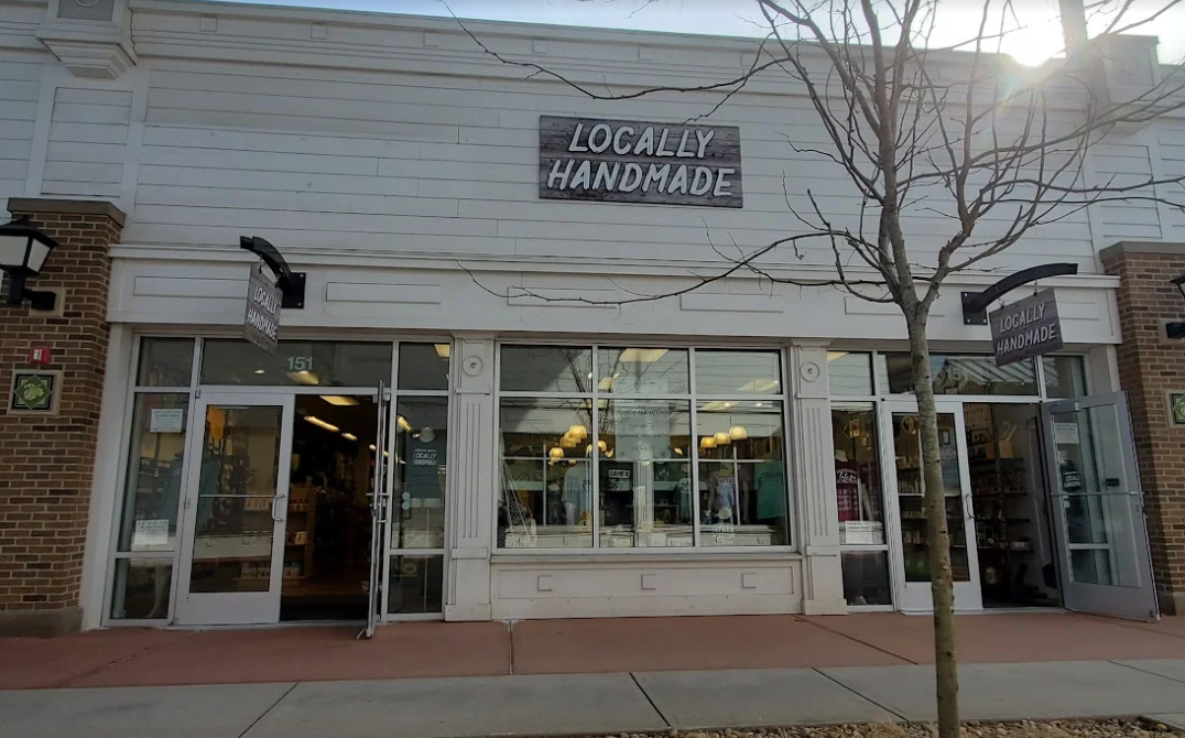 Storefront with 'Locally Handmade' sign on a sunny day