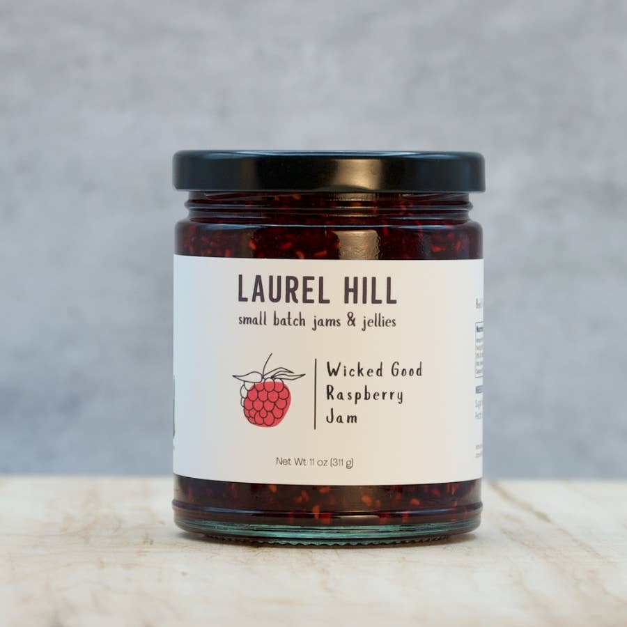 Jar of Laurel Hill Wicked Good Raspberry Jam on a neutral background