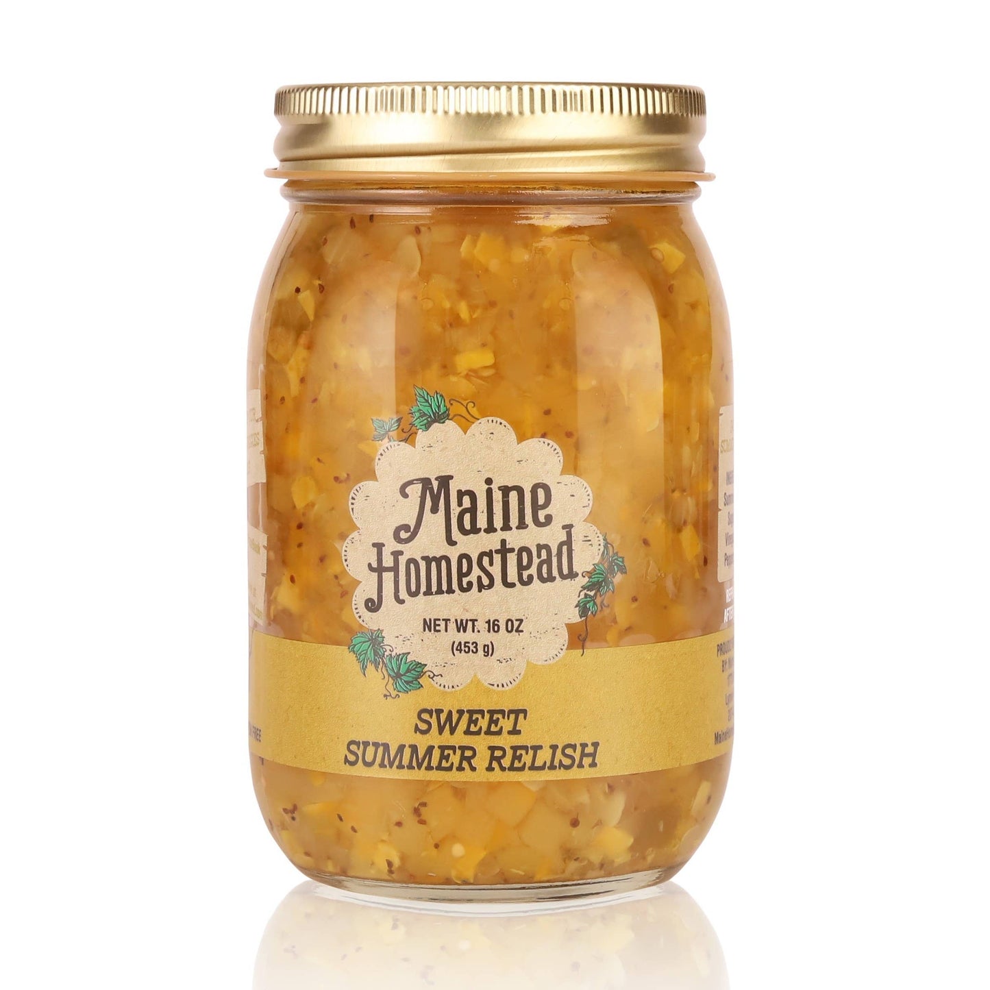 A glass jar of Maine Homestead Sweet Summer Relish with a gold metal lid and a cream-colored label, set against a plain white background with a subtle reflection.