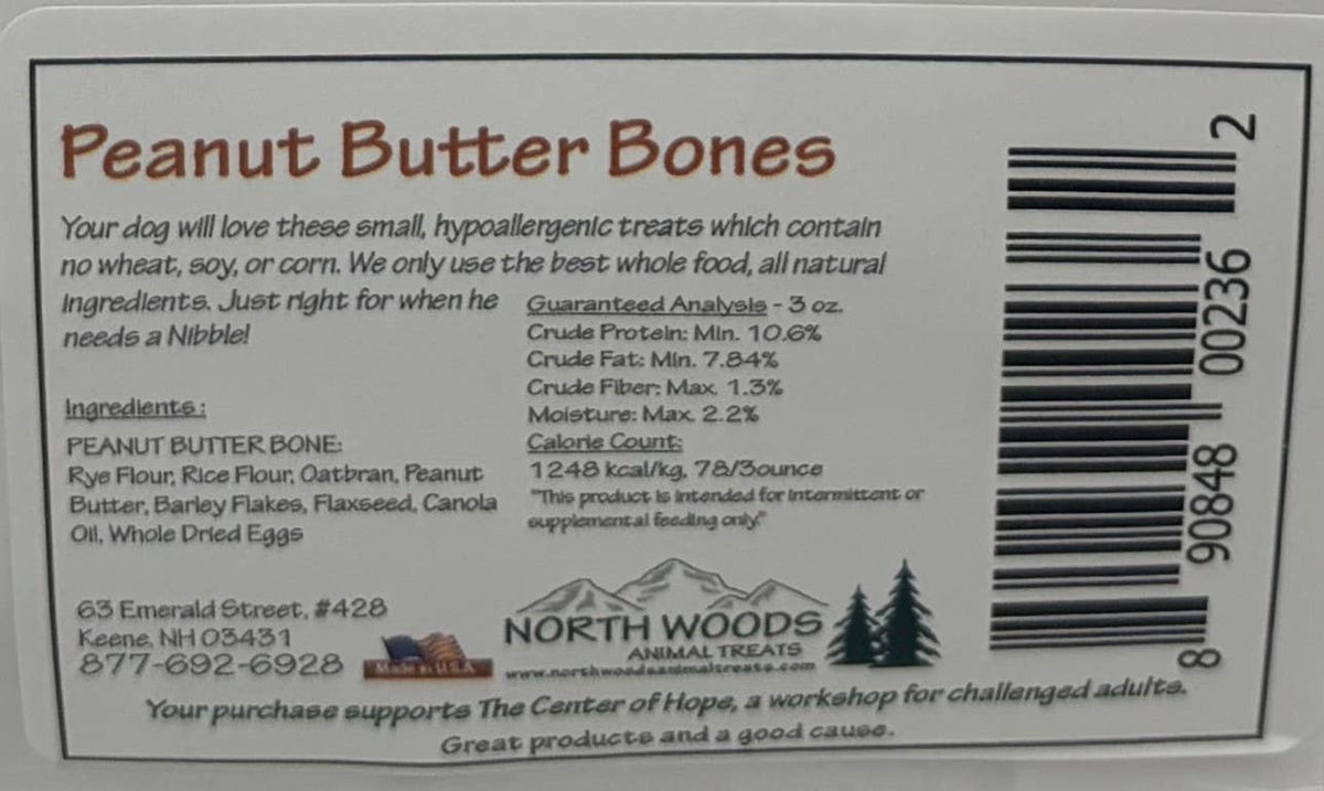 The back of a North Woods Animal Hope Peanut Butter Bones treat package, showing product information, ingredients, barcode, and a small logo at the bottom.
